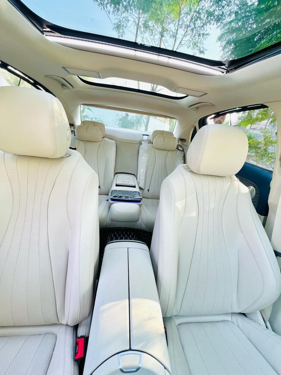 Mercedes-Benz E-Class cabin with cream seats and a panoramic sunroof